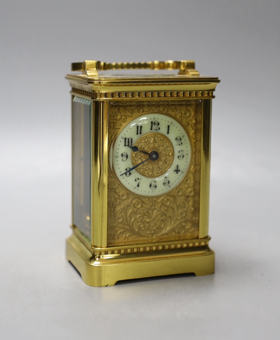 A cased French gilt brass carriage timepiece with relief cast dial and engraved presentation inscription - 14cm tall